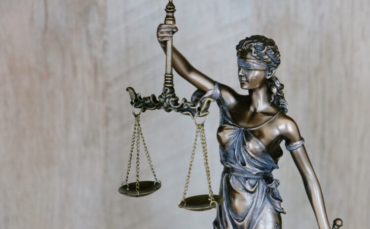 woman holding sword statue during daytime