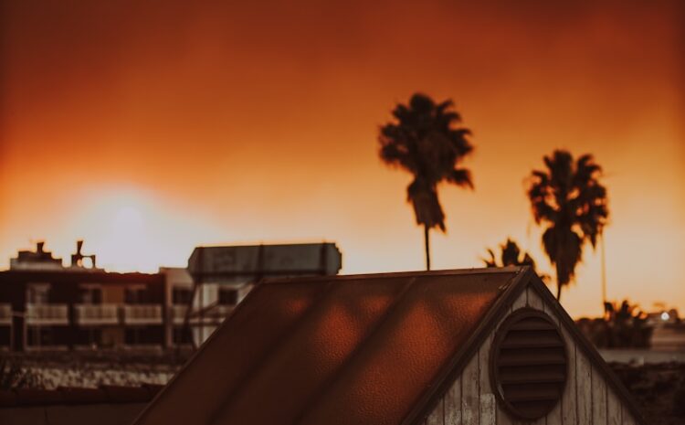 A picture of a house with a red sky in the background