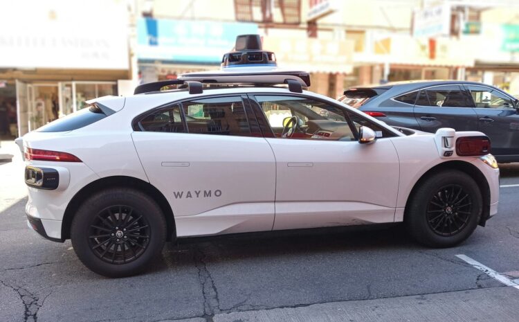 A waymo self-driving car is seen in the city.