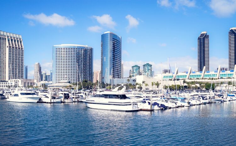 a harbor filled with lots of boats next to tall buildings