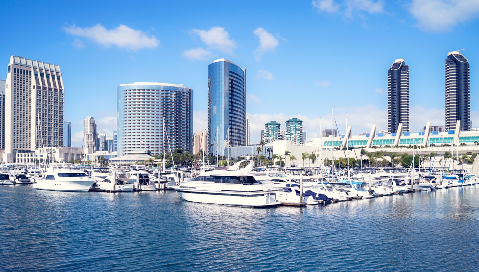 a harbor filled with lots of boats next to tall buildings